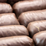 Bio-Schoko-Baumstämme (Nougat/Marzipan) von rosmarin BIOBACK – Erhältlich bei Kornkiste, der nachhaltigen Unverpackt-Online-Foodcoop. Bio, plastikfrei und ökologisch verpackt im praktischen Mehrweg-Großgebinde. Lose und ressourcenschonend für gemeinschaftliches, bewusstes Einkaufen. Jetzt online bestellen!